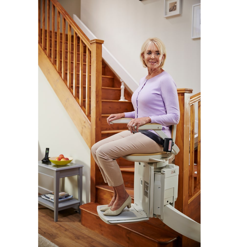Lady riding stairlift around the corner