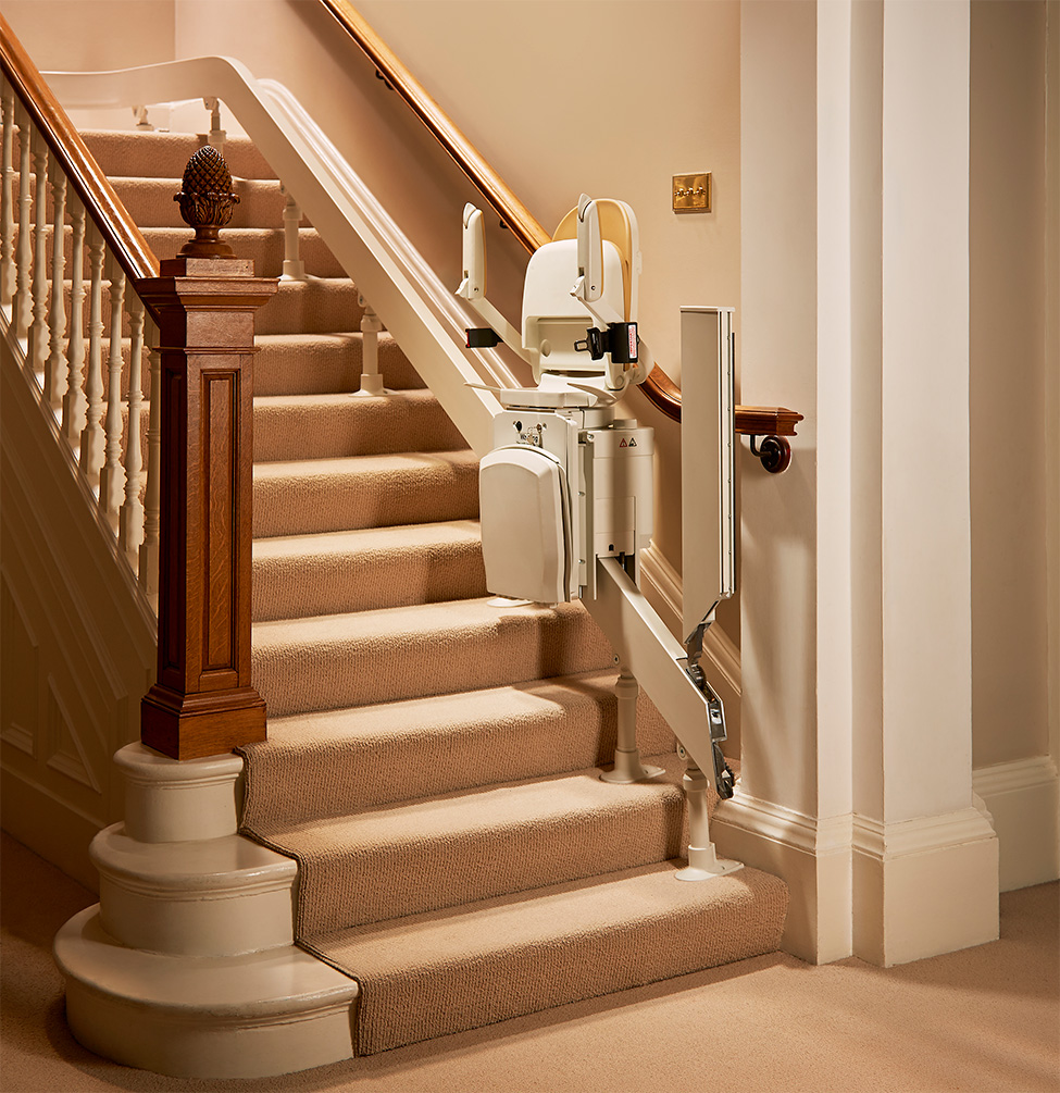 Curved stairlift folded up on stairs