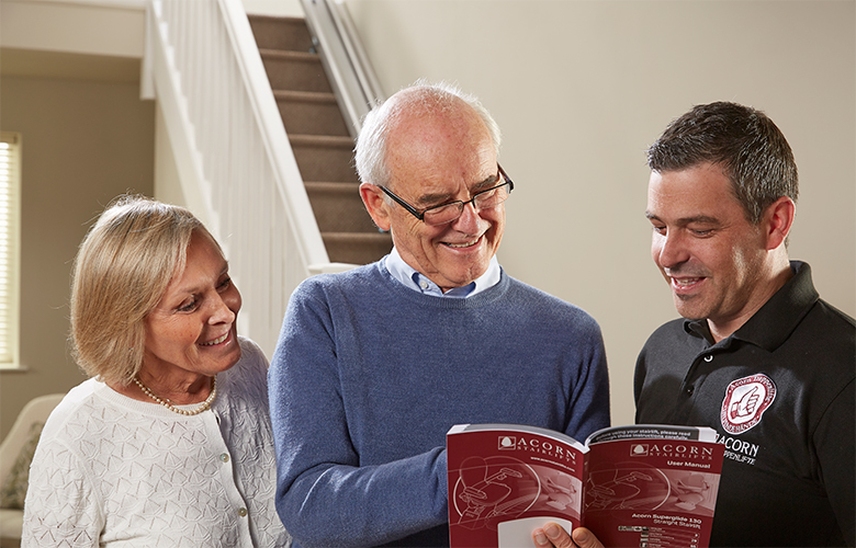 Acorn Stairlift Customers Going Over User Manual With Stairlift Tech